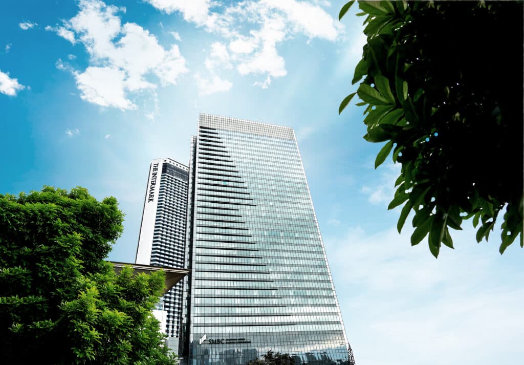 KWAP office tower viewed from below, surrounded by greenery